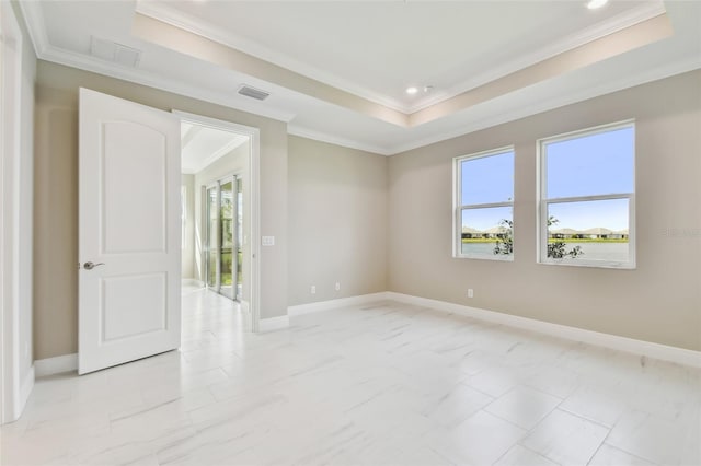 empty room with a tray ceiling and crown molding