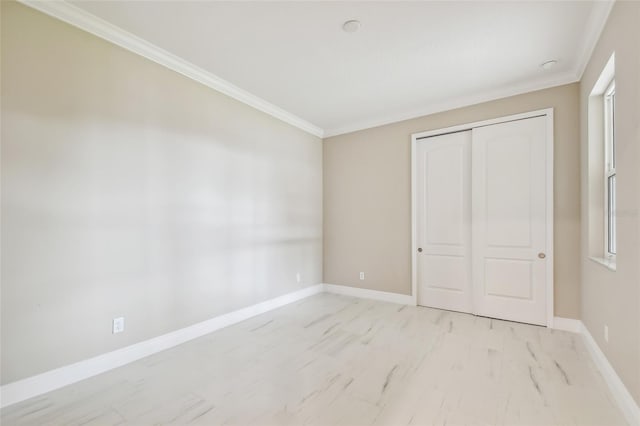 unfurnished bedroom with a closet and ornamental molding