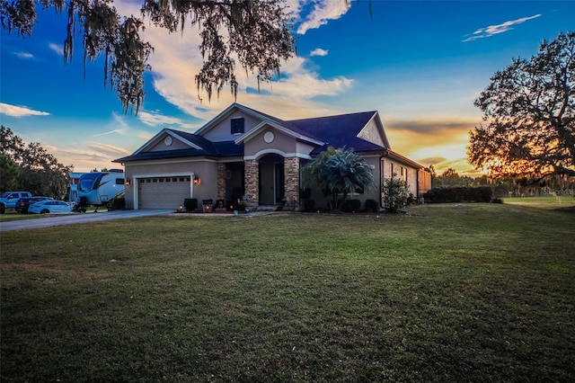 view of front of house featuring a garage and a lawn