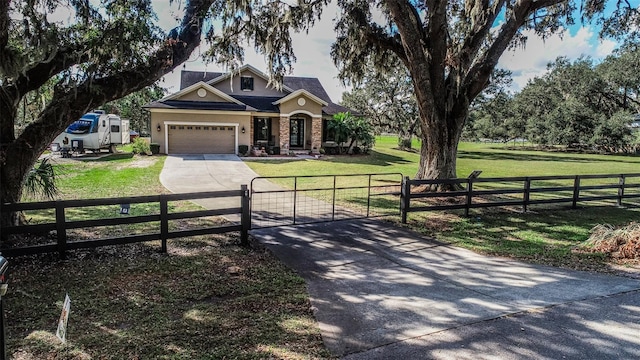 view of front of house with a garage and a front lawn