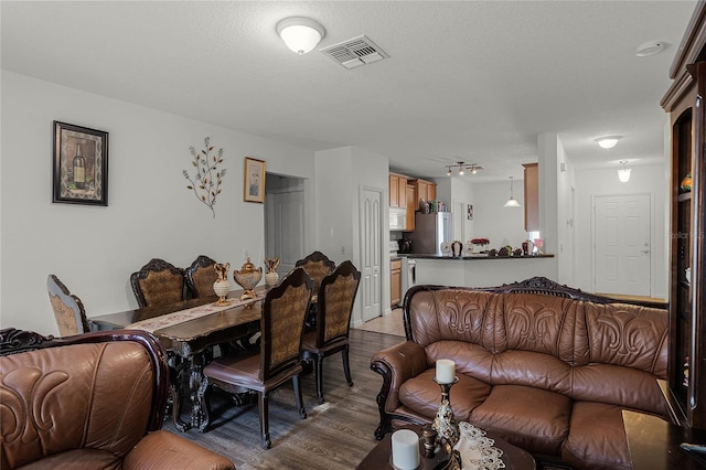 living room featuring hardwood / wood-style floors and a textured ceiling