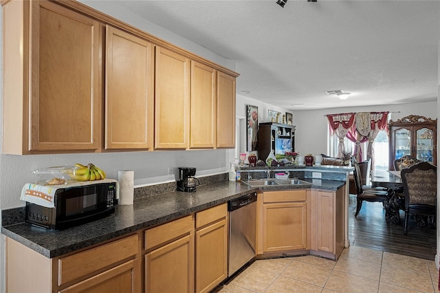 kitchen featuring sink, light hardwood / wood-style flooring, stainless steel dishwasher, kitchen peninsula, and a textured ceiling