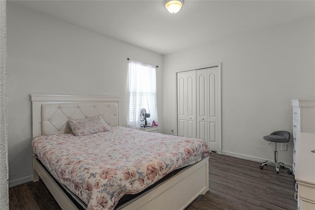 bedroom with a closet and dark hardwood / wood-style floors