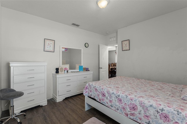 bedroom with dark wood-type flooring