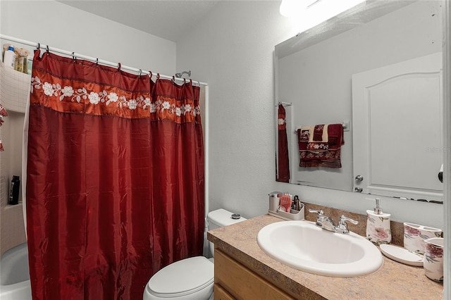 full bathroom with vanity, shower / tub combo, and toilet