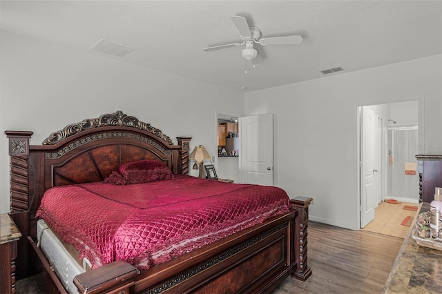 bedroom with ensuite bathroom, ceiling fan, and light hardwood / wood-style floors