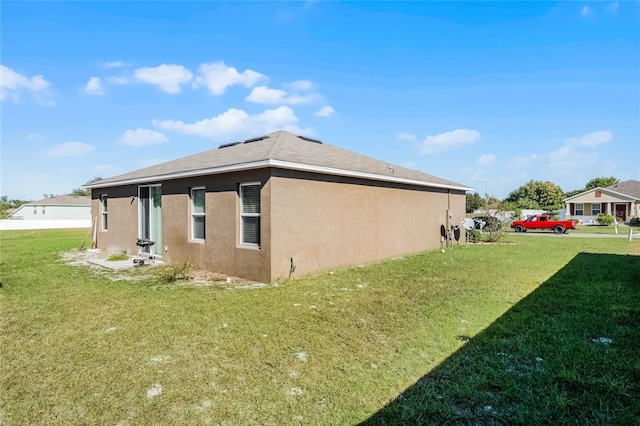 view of side of property with a yard