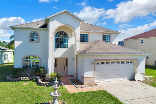 view of front of house featuring a front yard and a garage