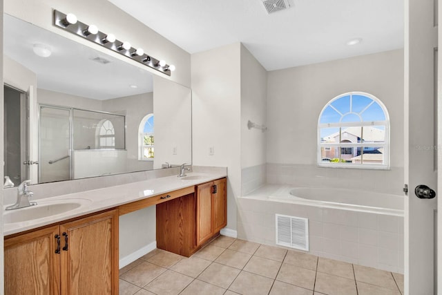 bathroom featuring tile patterned floors, vanity, and a healthy amount of sunlight