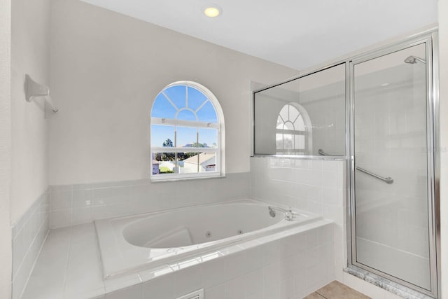 bathroom with tile patterned flooring and independent shower and bath