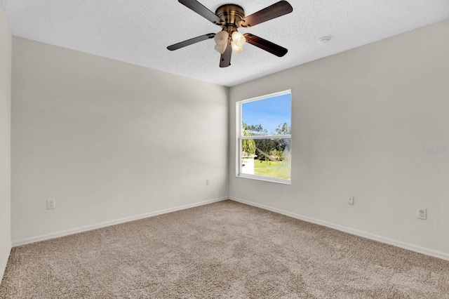 carpeted empty room featuring a textured ceiling and ceiling fan