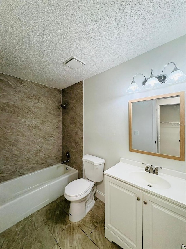 full bathroom with vanity, toilet, a textured ceiling, and tiled shower / bath