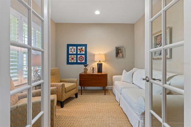 living area featuring carpet flooring and french doors