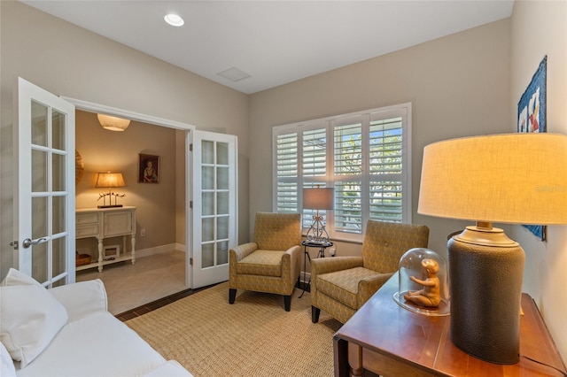 living area featuring tile patterned floors and french doors