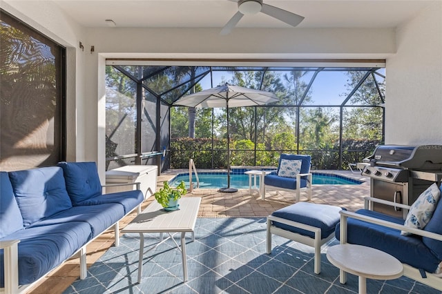 view of patio featuring area for grilling, ceiling fan, glass enclosure, and an outdoor living space