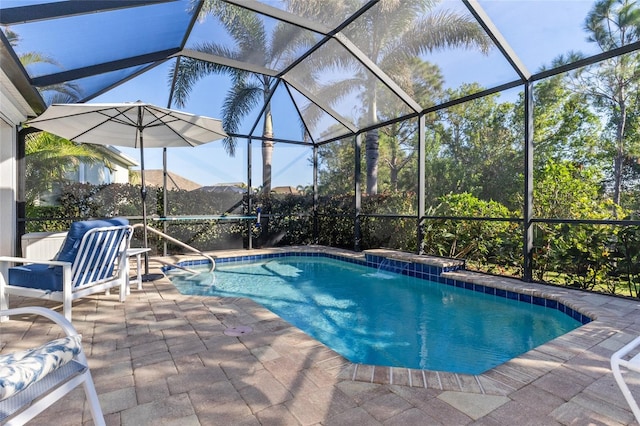 view of pool with pool water feature, glass enclosure, a mountain view, and a patio