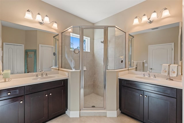 bathroom featuring tile patterned flooring, vanity, and walk in shower