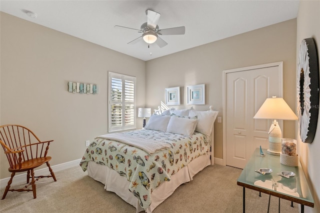 bedroom featuring light carpet and ceiling fan