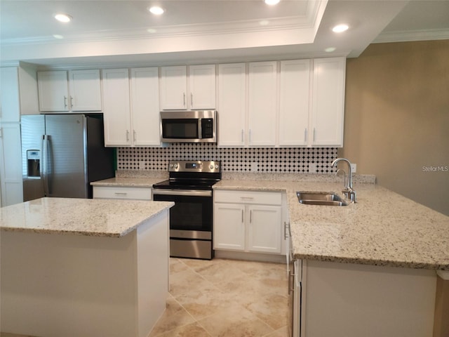 14071 Heritage Landing Blvd Unit 334, Punta Gorda, FL 33955 - kitchen featuring stainless steel appliances, crown molding, tasteful backsplash, white cabinetry, and a peninsula