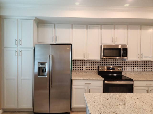 kitchen with light stone countertops, white cabinets, and appliances with stainless steel finishes