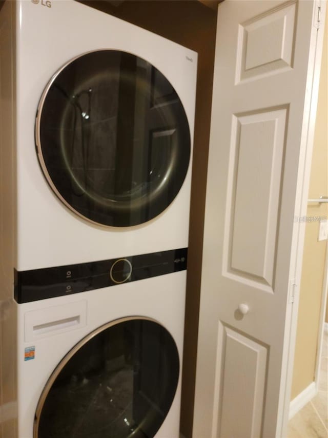 laundry area featuring stacked washer / dryer