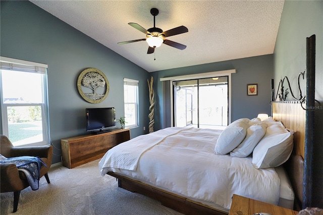 carpeted bedroom featuring a ceiling fan, access to exterior, vaulted ceiling, and a textured ceiling