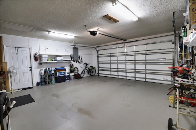 garage with a garage door opener and electric panel