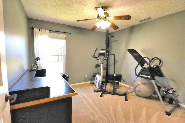 workout room featuring visible vents, carpet flooring, a textured ceiling, and baseboards