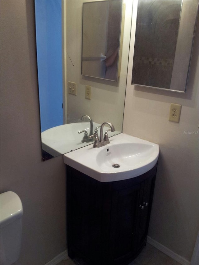 bathroom featuring vanity and toilet