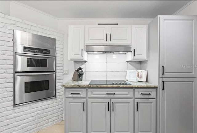 kitchen featuring light stone countertops, double oven, crown molding, black electric cooktop, and white cabinets