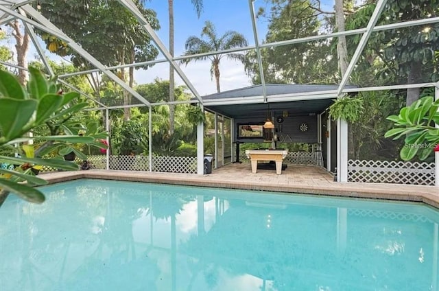 view of swimming pool with glass enclosure and a patio area