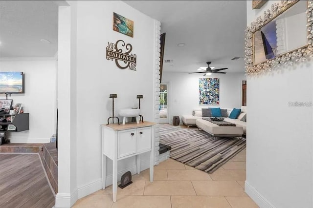 tiled living room with ceiling fan