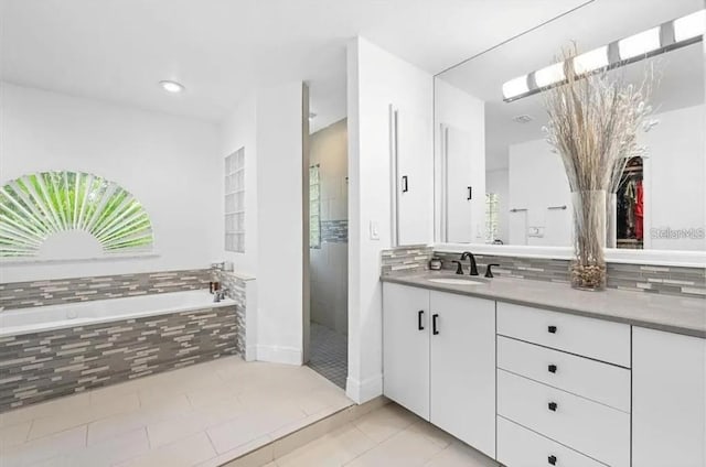 bathroom with separate shower and tub, tile patterned flooring, and vanity