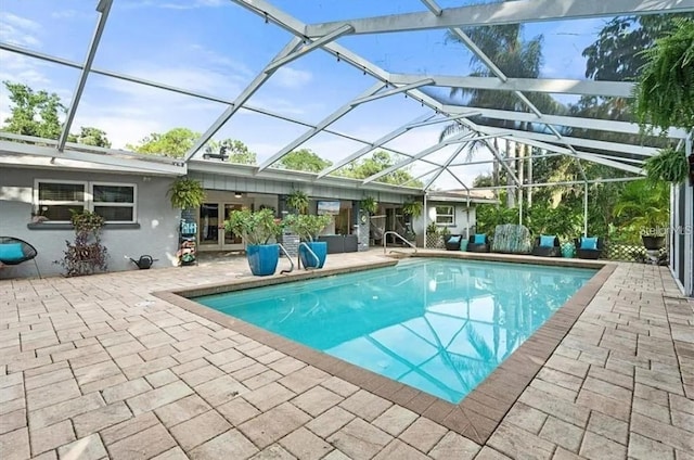 view of swimming pool featuring a patio area and a lanai