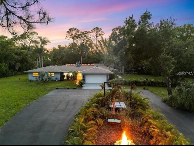 view of front facade featuring a garage and a yard