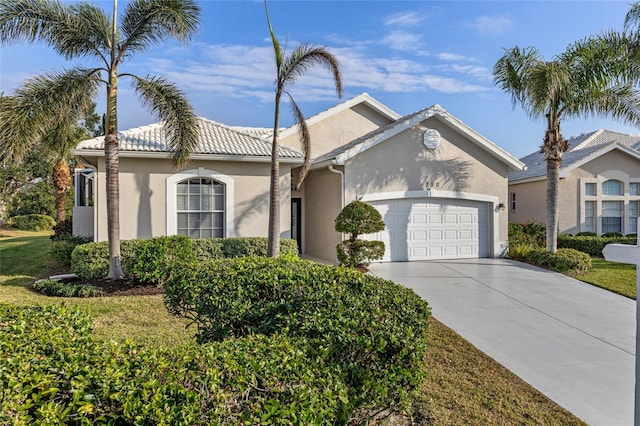 view of front of home with a front yard and a garage