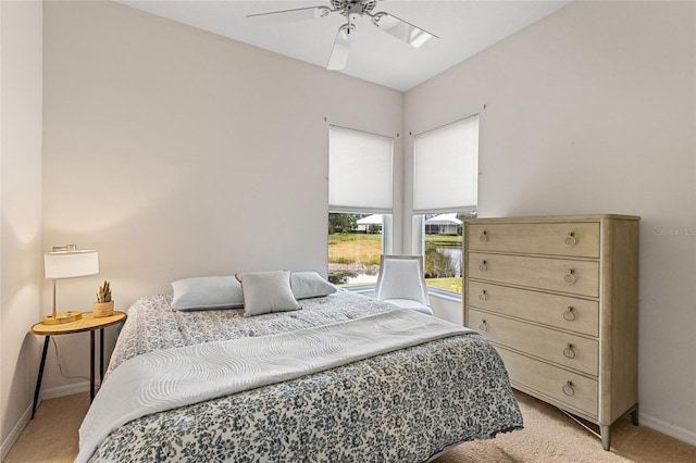 bedroom featuring ceiling fan and light colored carpet