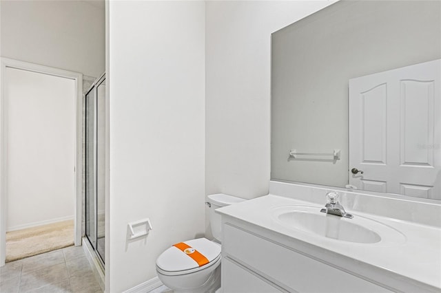 bathroom featuring tile patterned floors, an enclosed shower, vanity, and toilet