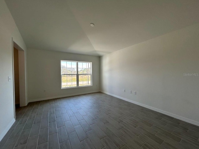 unfurnished room featuring dark wood-style floors and baseboards