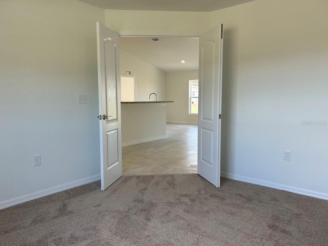 empty room with light carpet and baseboards