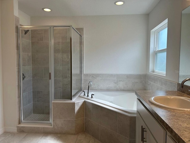 full bathroom featuring tile patterned flooring, a garden tub, recessed lighting, vanity, and a shower stall