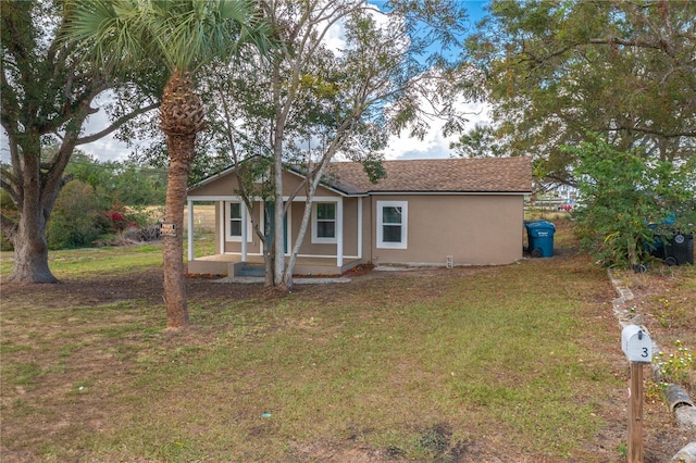 exterior space with covered porch and a front lawn