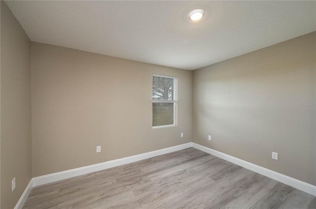 unfurnished room with light wood-type flooring