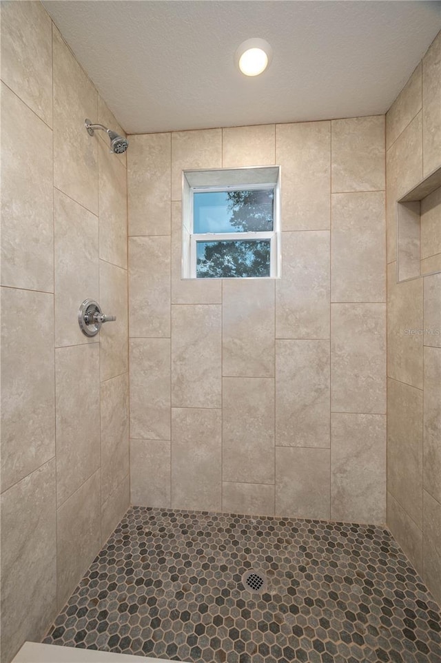 bathroom with a tile shower