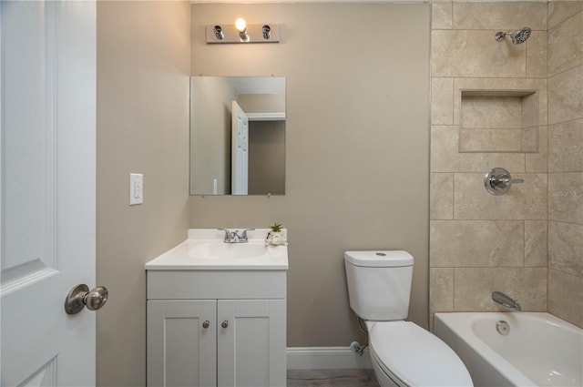 full bathroom with vanity, tiled shower / bath combo, and toilet