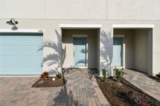 view of exterior entry with a garage