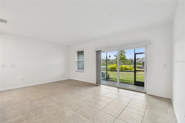 spare room featuring light tile patterned floors