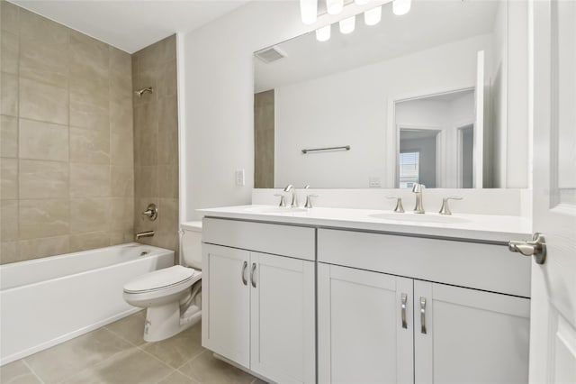 full bathroom with toilet, tile patterned flooring, tiled shower / bath combo, and vanity