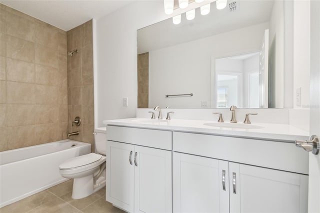 full bathroom featuring tiled shower / bath combo, vanity, toilet, and tile patterned flooring