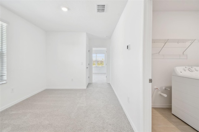 interior space featuring washer / dryer and light carpet